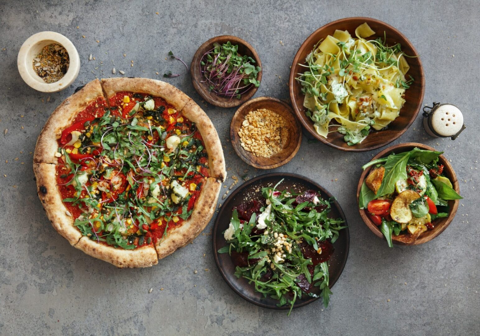 Assorted Italian dishes on a grey table.