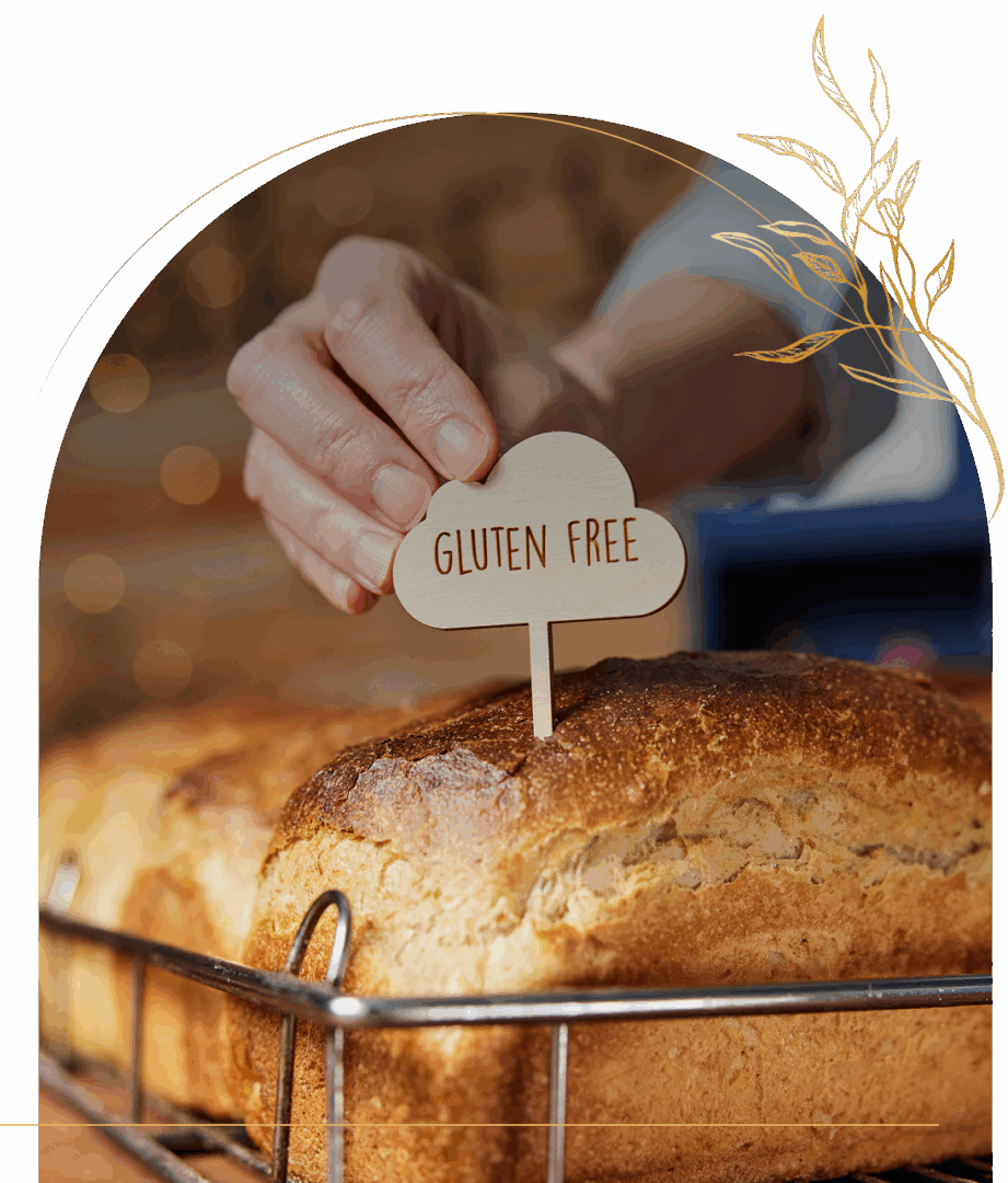 Hand placing gluten-free sign on bread.